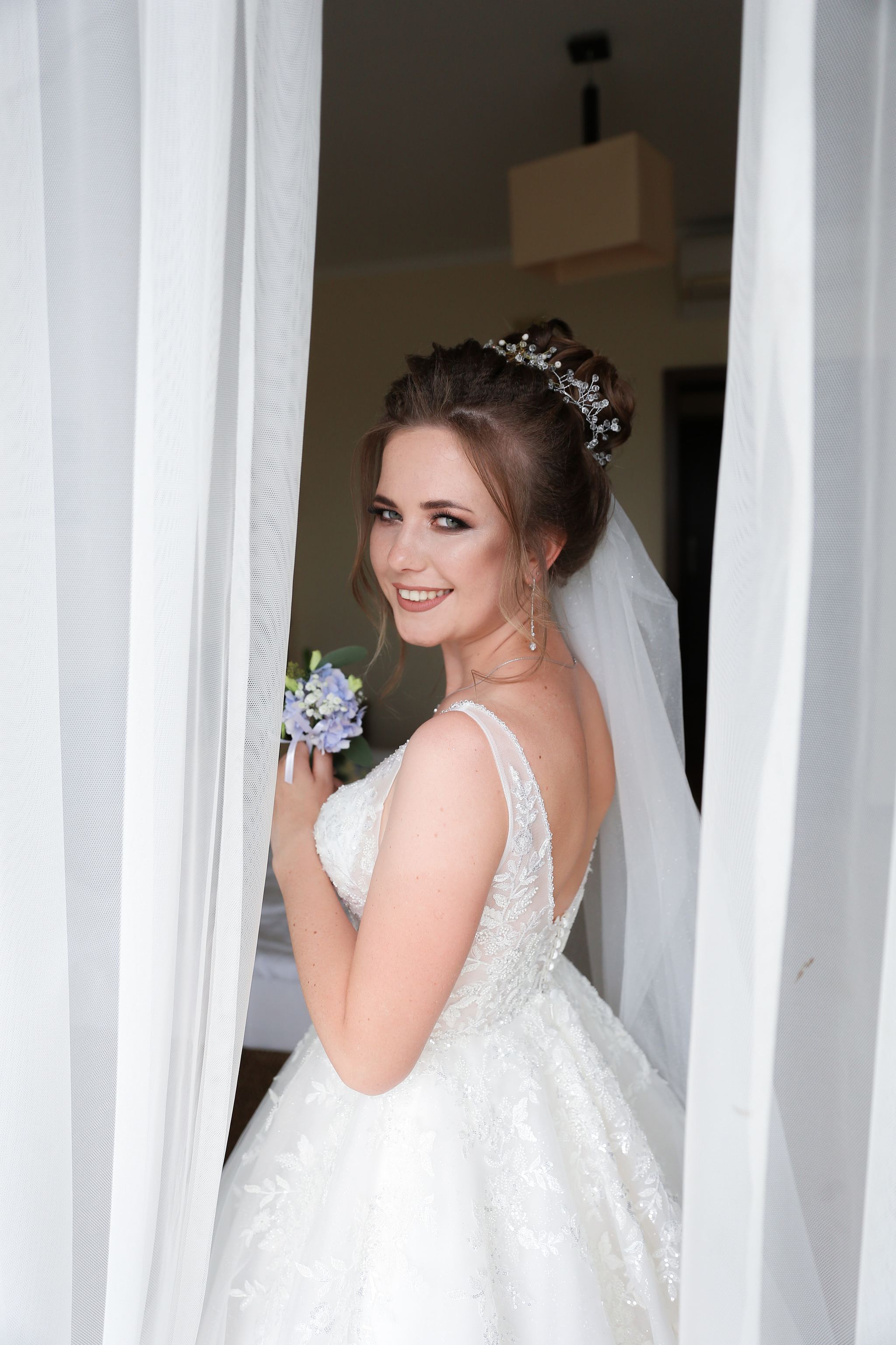Bride holding her wedding bouquet before the ceremony in Ukraine