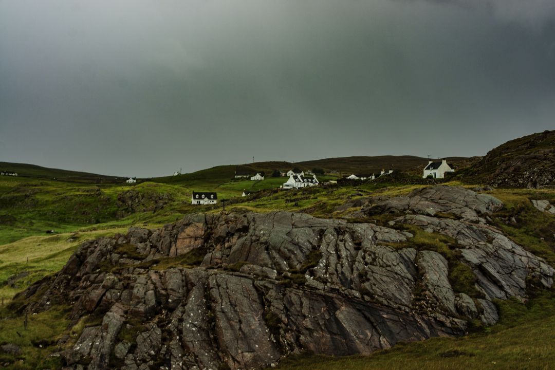 Rugged Highland landscape near Oldshoremore in north-west Scotland beneath a cloudy sky.