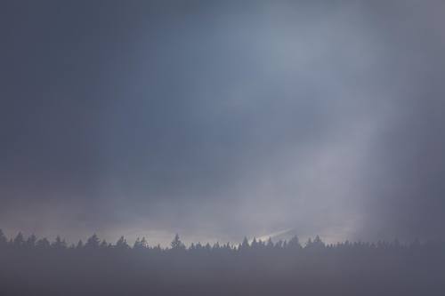Layered mountain ridges in soft blue mist – atmospheric fine art photography