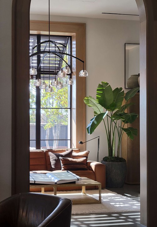A professionally staged interior design vignette featuring a luxury lounge chair and modern decor at the RH Gallery in Jacksonville, highlighting high-end furniture and soft natural lighting.