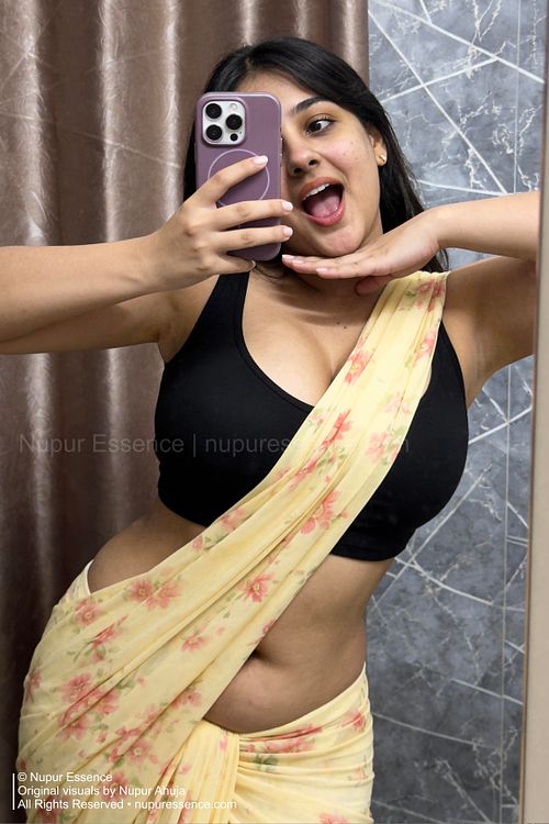 Nupur Ahuja in a modern yellow saree captured in a mirror selfie