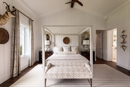 Wide-angle, one-point perspective of a luxury white guest room by AD Davis Construction.
