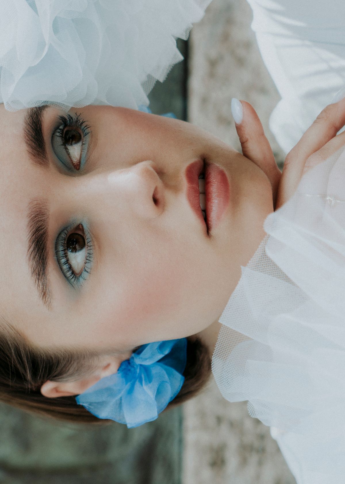Portrait of a model wearing handmade tulle earrings. Photographed by Filianna Karamanli.