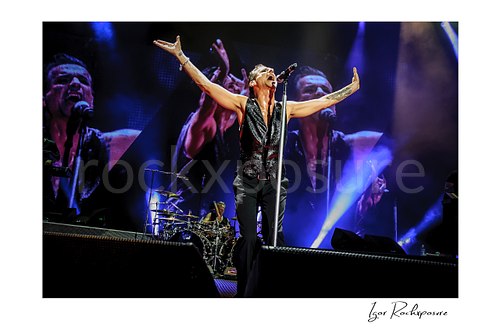 Horizontal color image of Depeche Mode members Dave Gahan and Christian Eigner performing on stage