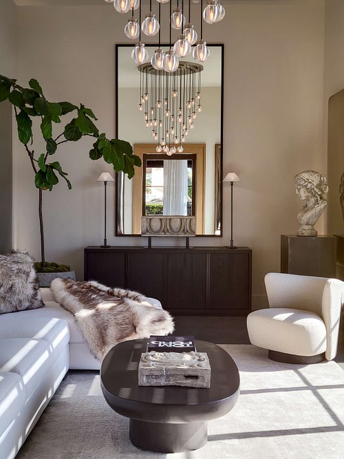 A vertical interior shot of a luxury residential living space, showcasing expert home staging, high-end furniture, and sophisticated modern interior design with curated decor.