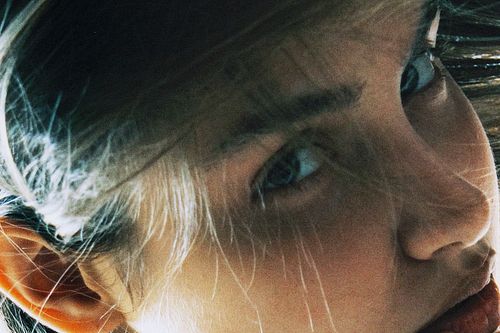 Editorial fashion close-up with expressive lighting and mood