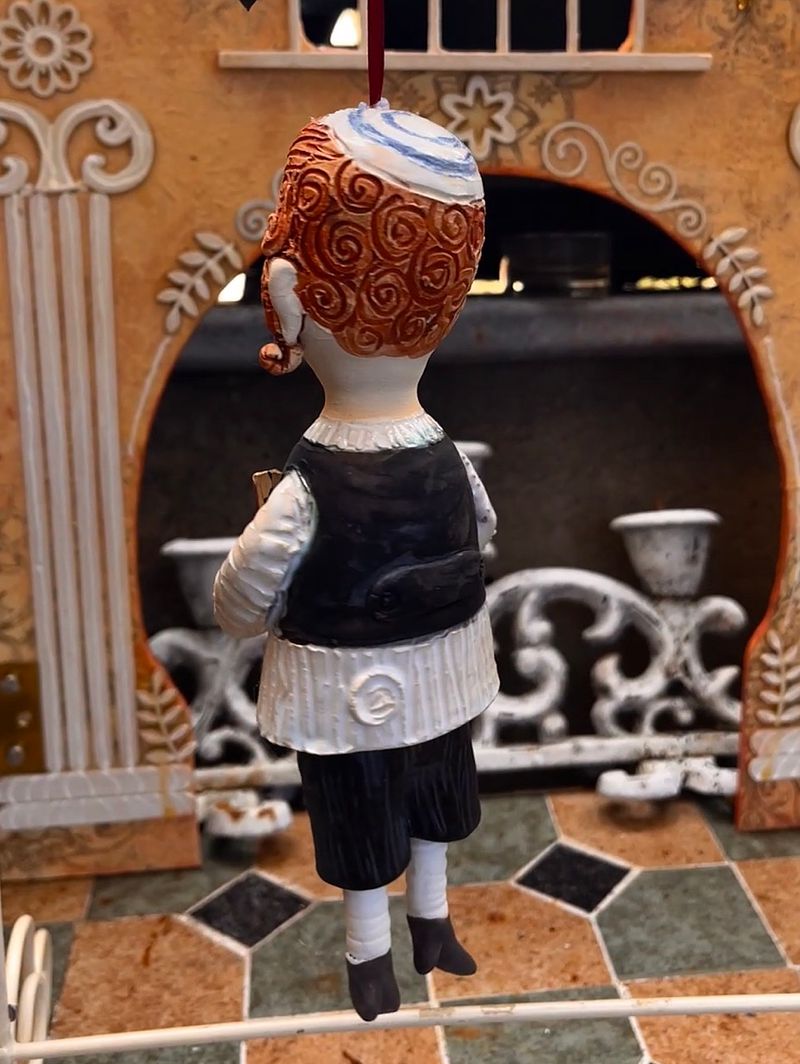 Traditional boy with a book, little ceramic hanging sculpture