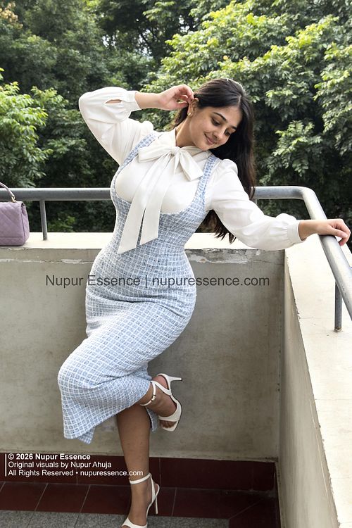 Nupur Ahuja for Nupur Essence wearing a blue tweed dress and white blouse on an outdoor balcony