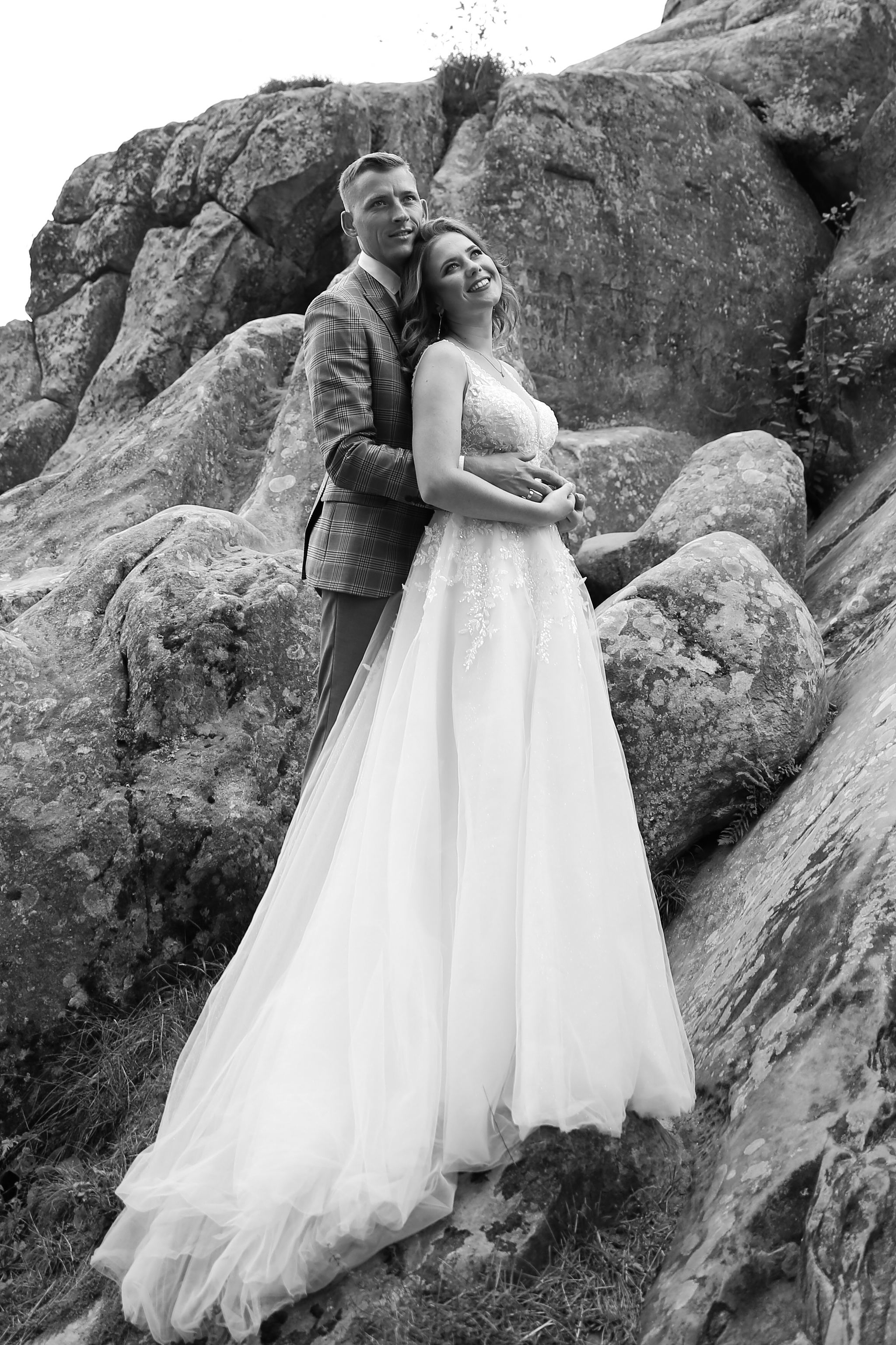 Bride and groom wedding portrait on the rocks at Tustan Fortress, Ukraine