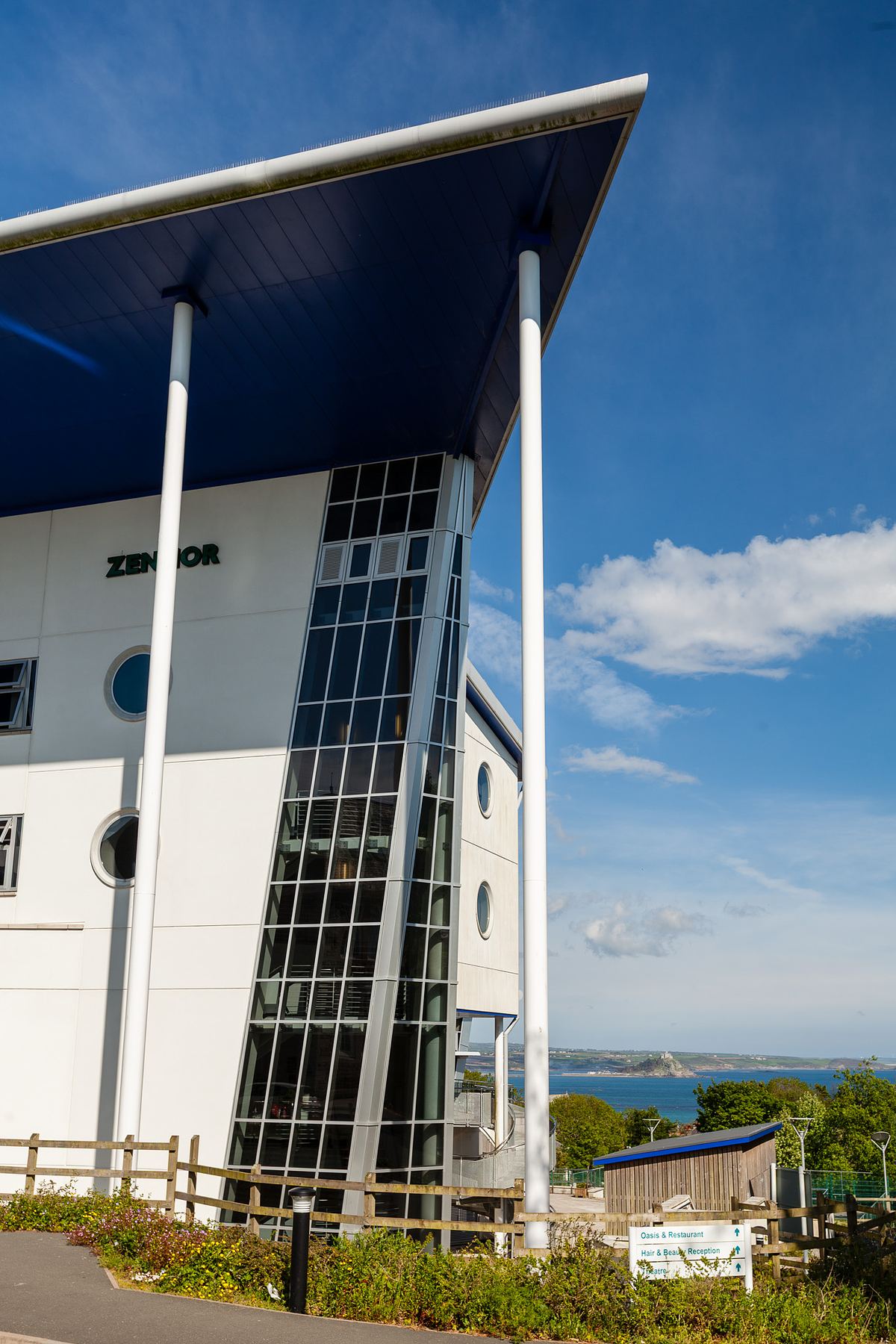 Close-up view of Penwith College building in Cornwall with angular glazing and white rendered façade.