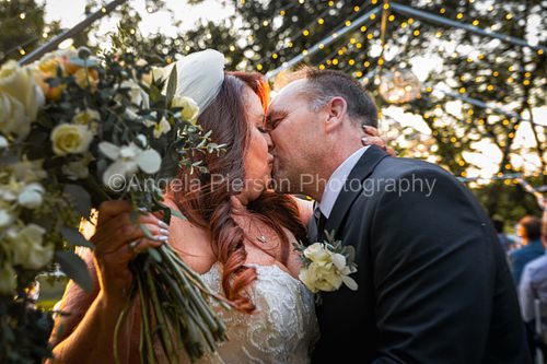 A bride and groom kiss in a passionate embrace - Rapid City Wedding Photography